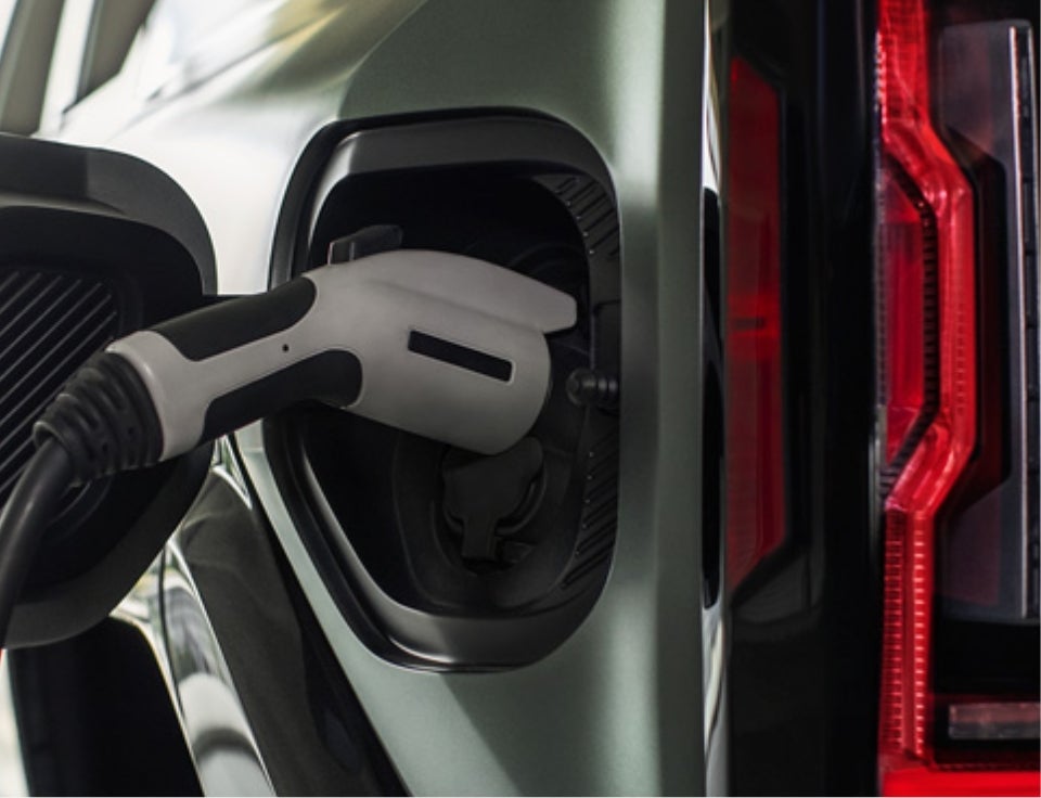 Close up of charging port with charger plugged in on a GMC Hummer EV SUV - Ruddell Auto GMC in Port Angeles WA